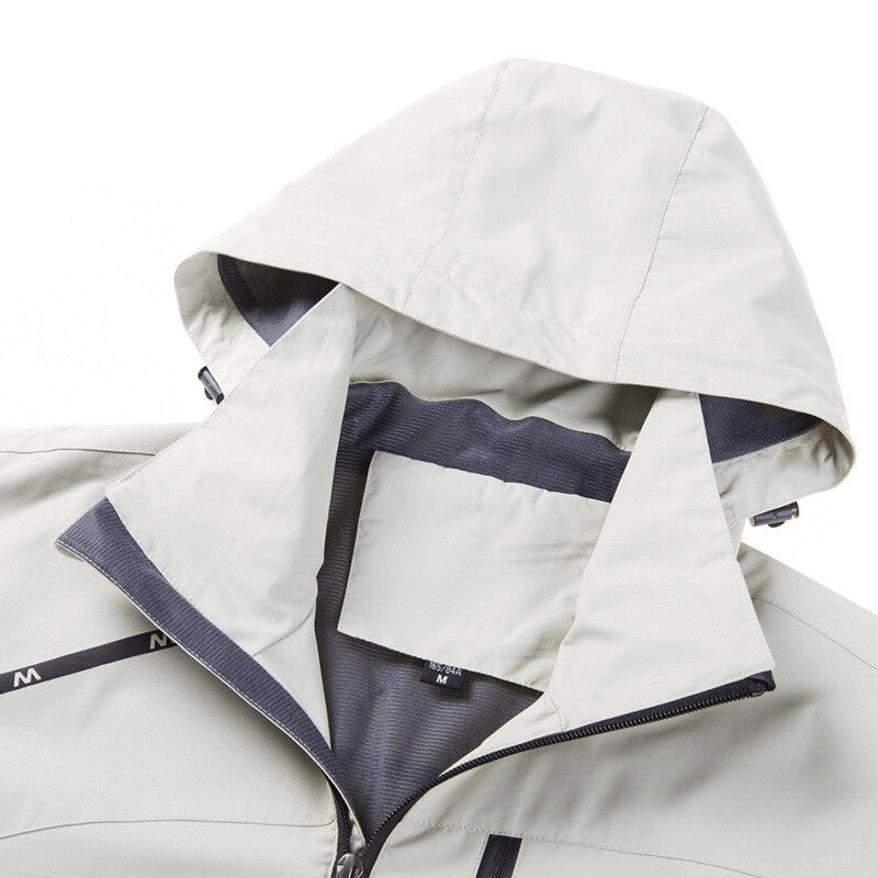 Close-up of lightweight windproof women's jacket with hood and fleece lining, ideal for outdoor activities.